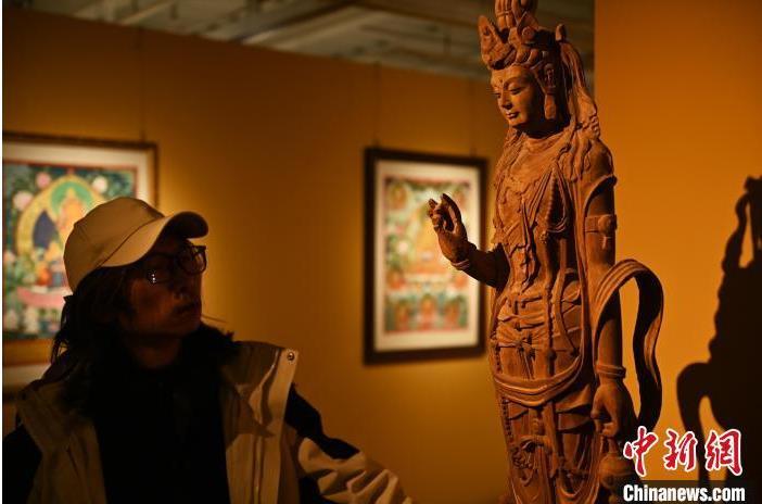 圖為季茂杰觀察自己創(chuàng)作的敦煌木雕。李亞龍 攝</p>
<p>